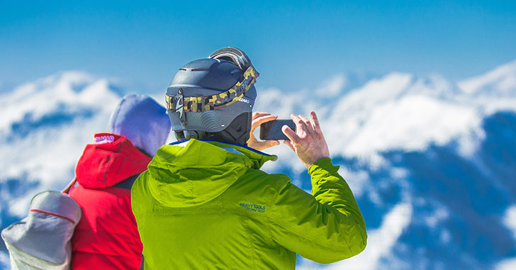 スキー場で写真を撮るカップル
